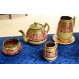 Brown glazed and lustre ceramic tea service to include: 2 jugs, teapot stand, teapot ,