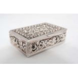 A white metal pill box with foliate decoration CONDITION: Please Note - we do not