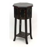 A 20thC Octagonal cabinet standing on four legs with shaped under tier.
