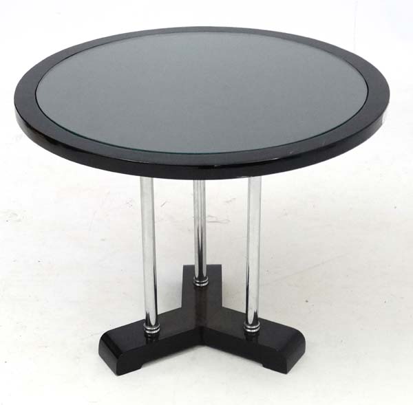 Art Deco : a chrome three legged circular coffee table with inset glass top ,