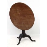 An early 19thC mahogany tripod table with one piece tilt top 31" diameter x approx 27 1/4" high