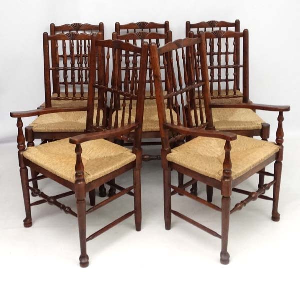 A set of 8 (6+2) oak spindle back chairs with envelope rush seats .