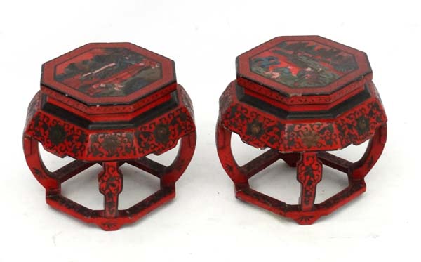 Chinese : a pair of red lacquer octagonal pot stands with polychromed images to top and decorated