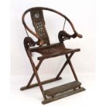 Chinese :A hardwood folding horseshoe-back armchair, JIAO YI , with a rounded crestrail ,