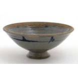 A small Studio pottery bowl on pedestal base decorated with cobalt blue detail on a blue / grey
