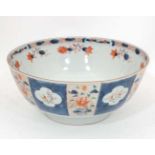 A Japanese style bowl in Imari colours having panels decorated with flowers and gilt highlights.