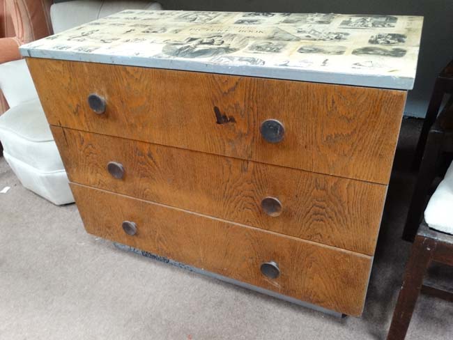 Mid 20thC painted chest of drawers with silver painted sides and decoupage top