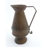 A large copper pedestal jug / ewer with angular handle. 20'' high.