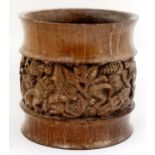 An African turned wooden pot with banded detail depicting figures at work etc.