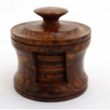 12 burr walnut coasters of cylindrical form within a cylindrical holder with lid.