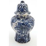 A small blue and white Delft lidded baluster form jar and cover,