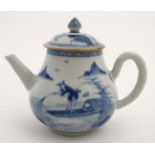 A Chinese blue and white teapot decorated to sides with figure in a boat fishing on a lake in a