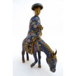 A Chinese gilt and Cloisonne censer formed as a figure on horseback wearing a hat and holding a