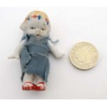 A Small continental miniature bisque doll with jointed arms.