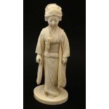 A Japanese Ivory Meiji okimono of a female figure holding a fan 7 3/8" high CONDITION: