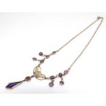 A gilt metal necklace set with facet cut amethyst coloured detail and drop .