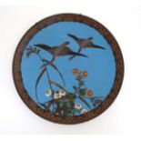 An Oriental Cloisonne charger depicting 2 Geese in flight .