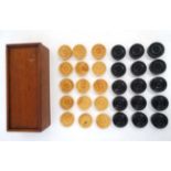A set of wooden checkers / draughts set, finished in black and natural , in a wooden box.