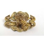 A gilt metal Art Nouveau brooch with female head to centre.