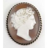 A classical carved shell cameo in a white metal mount 2” high CONDITION: Please