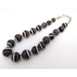 A string of graduated banded agate beads.
