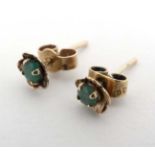 A pair of yellow metal stud earrings set with emeralds CONDITION: Please Note - we