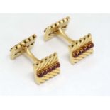 Van Cleef & Arpels : A pair of 18ct gold cufflinks with chevron design set with rows of rubies.