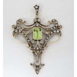 A 9ct gold pendant set with central peridot and a profusion of seed pearls 1 ¾" high