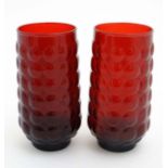 A pair of retro 20thC Anchor & Hocking red glass high ball glasses with raised dimple decoration.