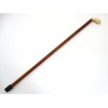 Walking Stick : A 19 thC ivory palm swell handle on a malacca shaft ,