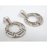 A pair of white metal drop earrings with stylised Greek Key decoration.