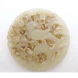 An oriental white jade pierced disc with image of bird amongst prunus 2 1/2" diameter