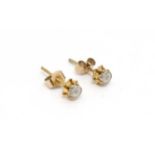 A pair of gilt metal stud earrings set with illusion set white stones.