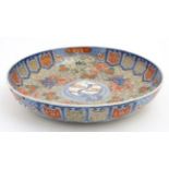 A Large Chinese bowl decorated in Imari style colours on a white ground,