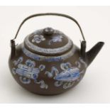 A Chinese Yixing style studio pottery matte brown teapot with lid having blue and white enamel