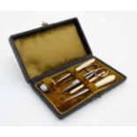 A c.1900 necessaire box opening to reveal a quantity of sewing tools.