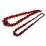 2 Vintage necklaces of graduated cherry amber coloured beads.