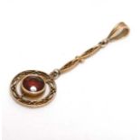 A yellow metal pendant set with garnet 1 ¼” long CONDITION: Please Note - we do