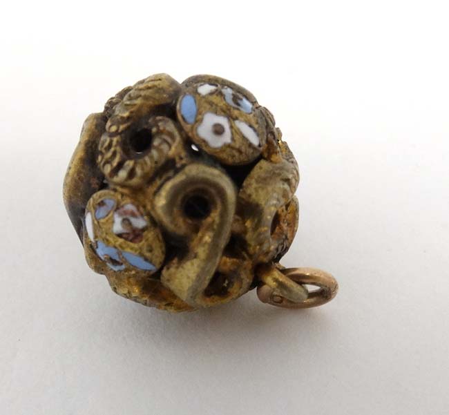 A gilt metal pendant of spherical form with enamel decoration.