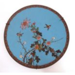 An Oriental Cloisonne charger depicting 2 sparrows amongst prunus and chrysanthemums,