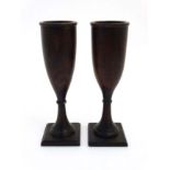 A pair of walnut turned flutes on squared bases 7 7/8" high CONDITION: Please Note