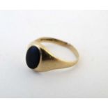 A 9ct gold ring signet set with onyx cabochon CONDITION: Please Note - we do not