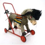 A 1960s Merrythought Toys Push Along Donkey on red painted metal base,