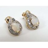 A pair of 9ct gold earrings set with opals, white stones and green stone. Approx.