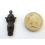 A pendant / charm formed as a kewpie doll 1 ¼” long CONDITION: Please Note - we