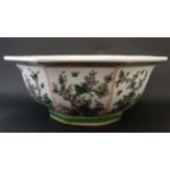 A large Chinese bowl of tapering octagonal form , the 8 panels decorated in shades of green,