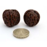 2 Japanese large ojimie beads in the form of a carved walnuts with central hole.