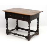An 18thC oak side table with frieze drawer ( having later carving) and turned baluster legs and