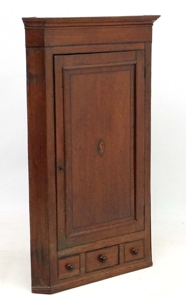 A Georgian shell inlaid oak and cross banded mahogany corner cupboard with one real and 2 sham