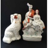 A 19thC Staffordshire flat back clock figure group , modelled as a Scottish couple. 13 1/2'' high.